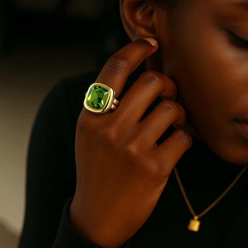 black woman wearing square cushion cut green diamond ring – gold bamboo band | Glowvy
