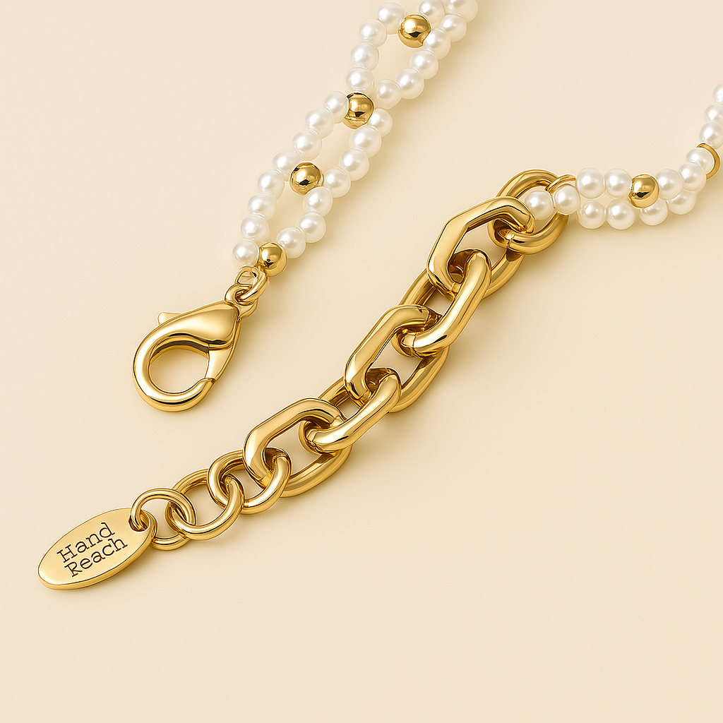 close-up of gold pearl bracelet with delicate charms – 14k gold-plated copper and lab-grown pearls

