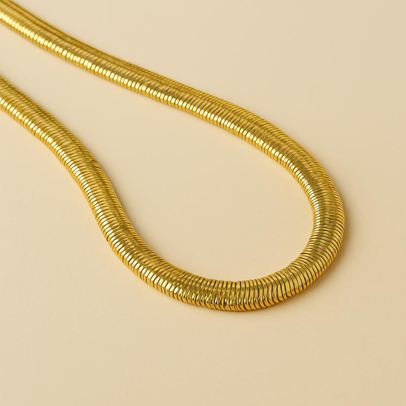 close-up of gold snake chain necklace – 14k gold plated copper with smooth reflective finish
