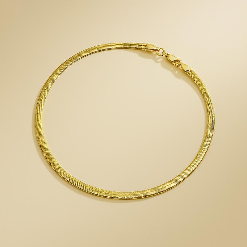 gold snake necklace with sleek chain design – 14k gold plated copper on oat beige background
